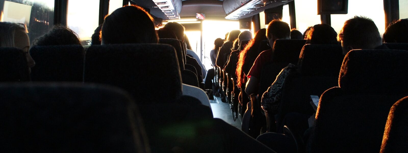 people riding passenger bus during daytime