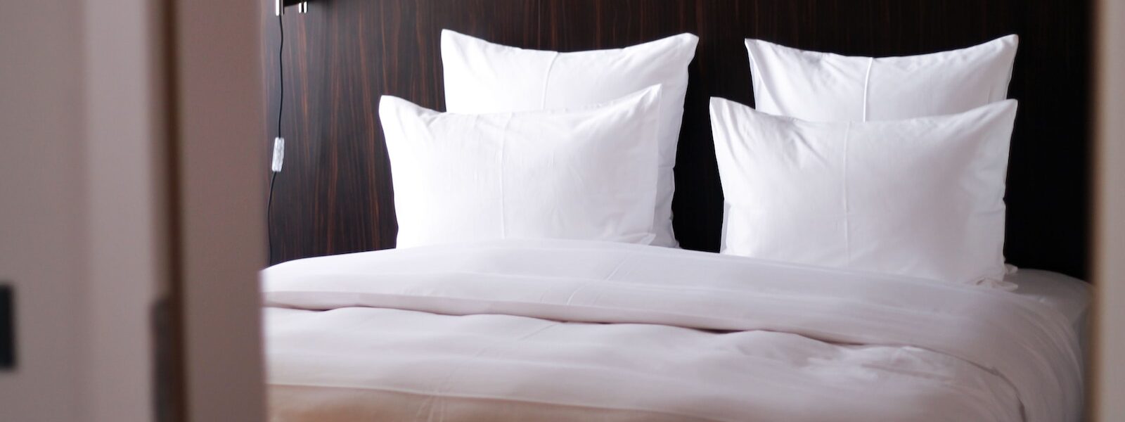 white bed pillow on white bed