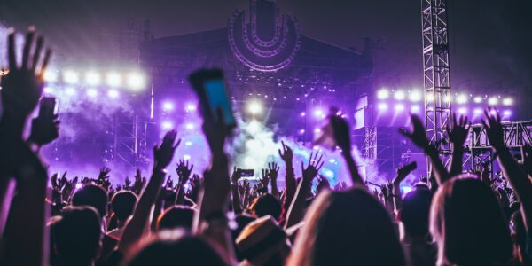 group of people raising there hands in concert