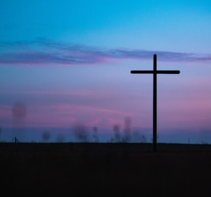 cross stand under purple and blue sky